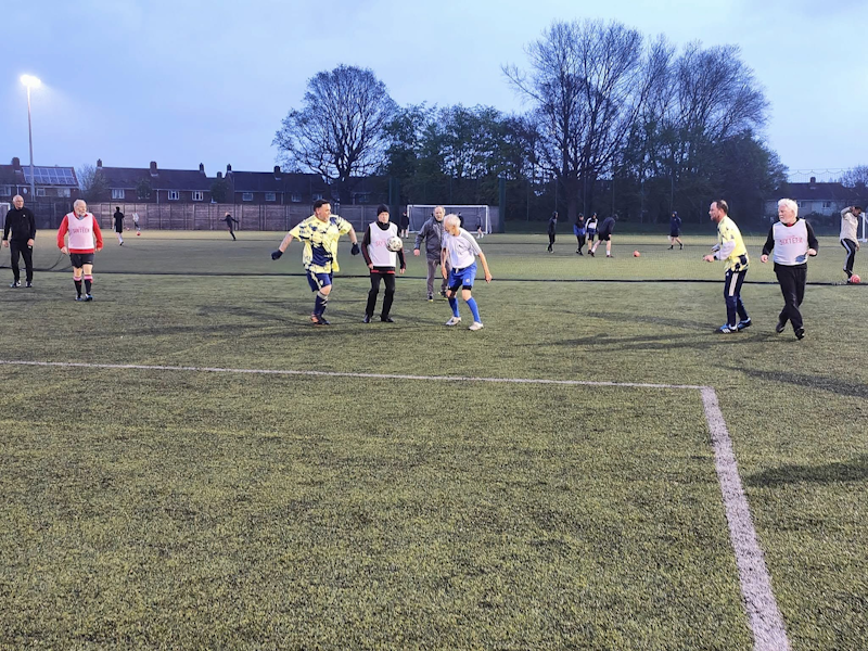 Replace with a landscape action photograph from a normal GWFC training session on the 5G pitch. Show real play and a range of participants. Landscape orientation, 4:3 crop.